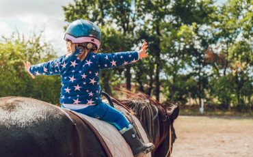 girl riding black horse